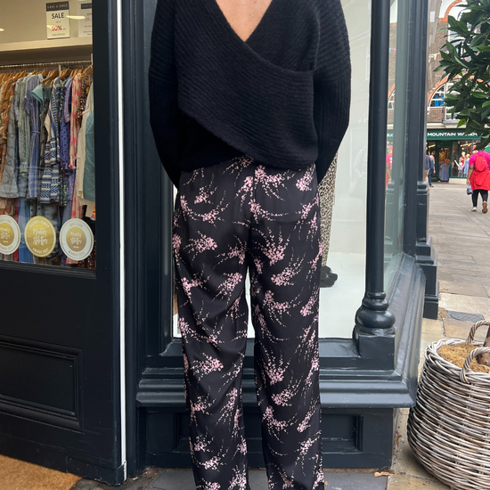 Black trousers with a pink firework print 