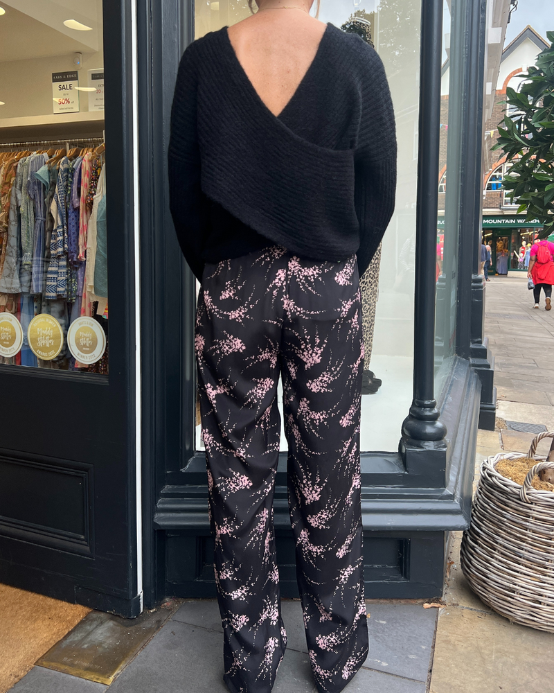 Black trousers with a pink firework print 
