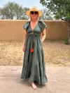 V neck khaki maxi dress with empire line short ruffle sleeves and tie with orange tassels and triple tiered skirt