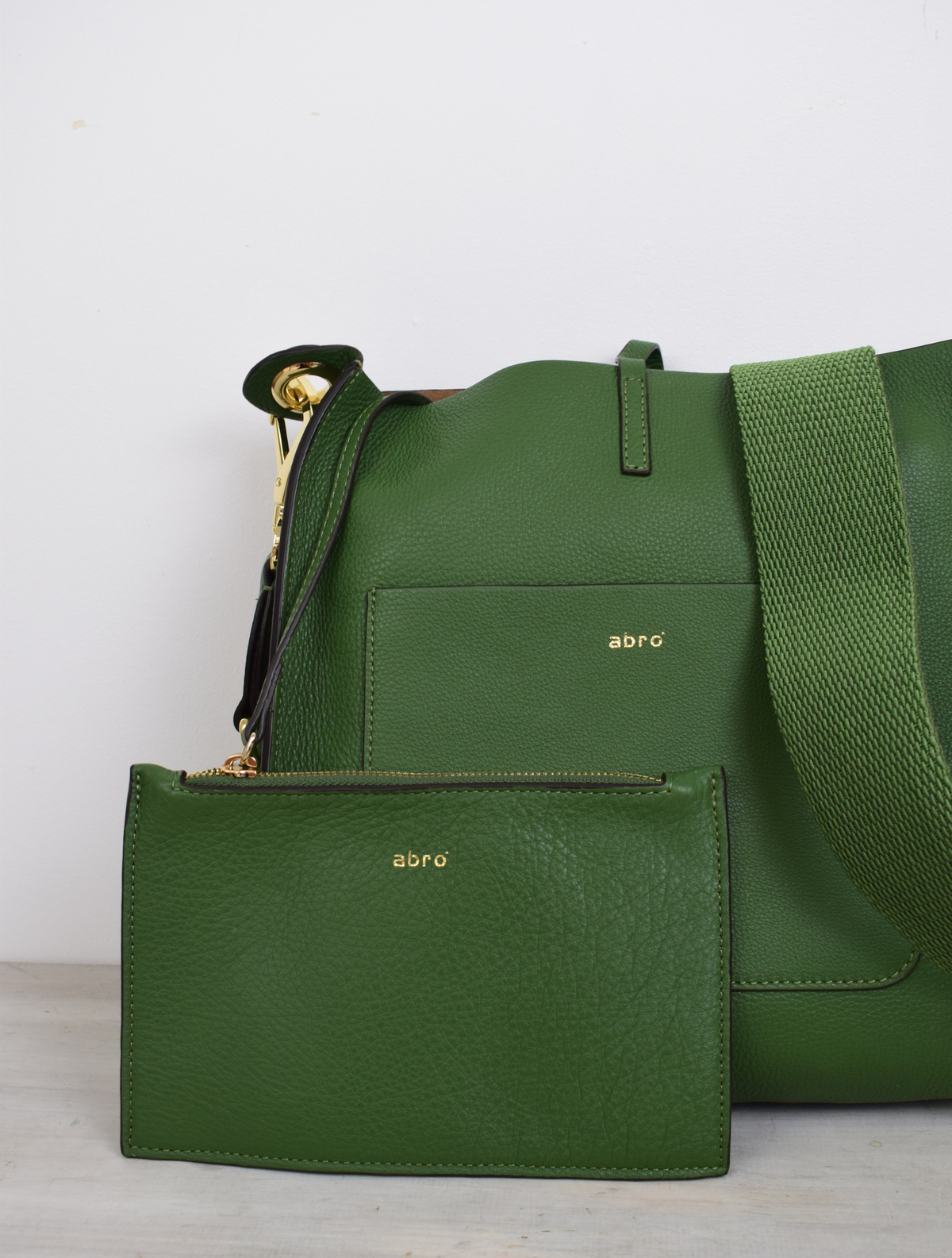 Green leather bag with cross body strap and front pocket detail