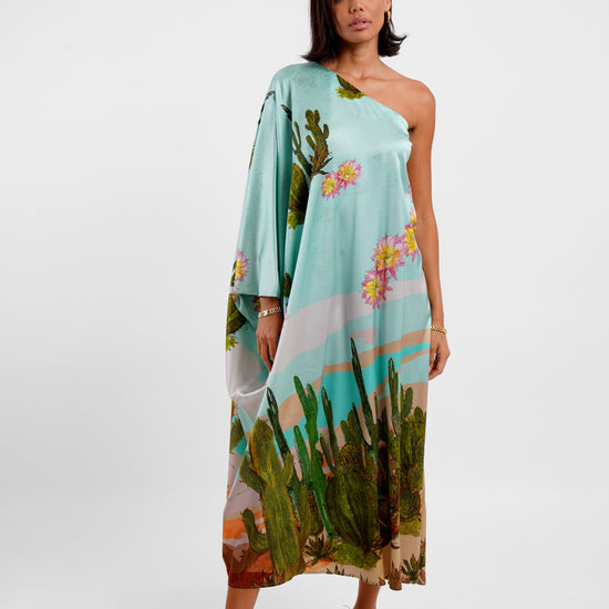 Woman wearing a floral one-shoulder dress on a white background