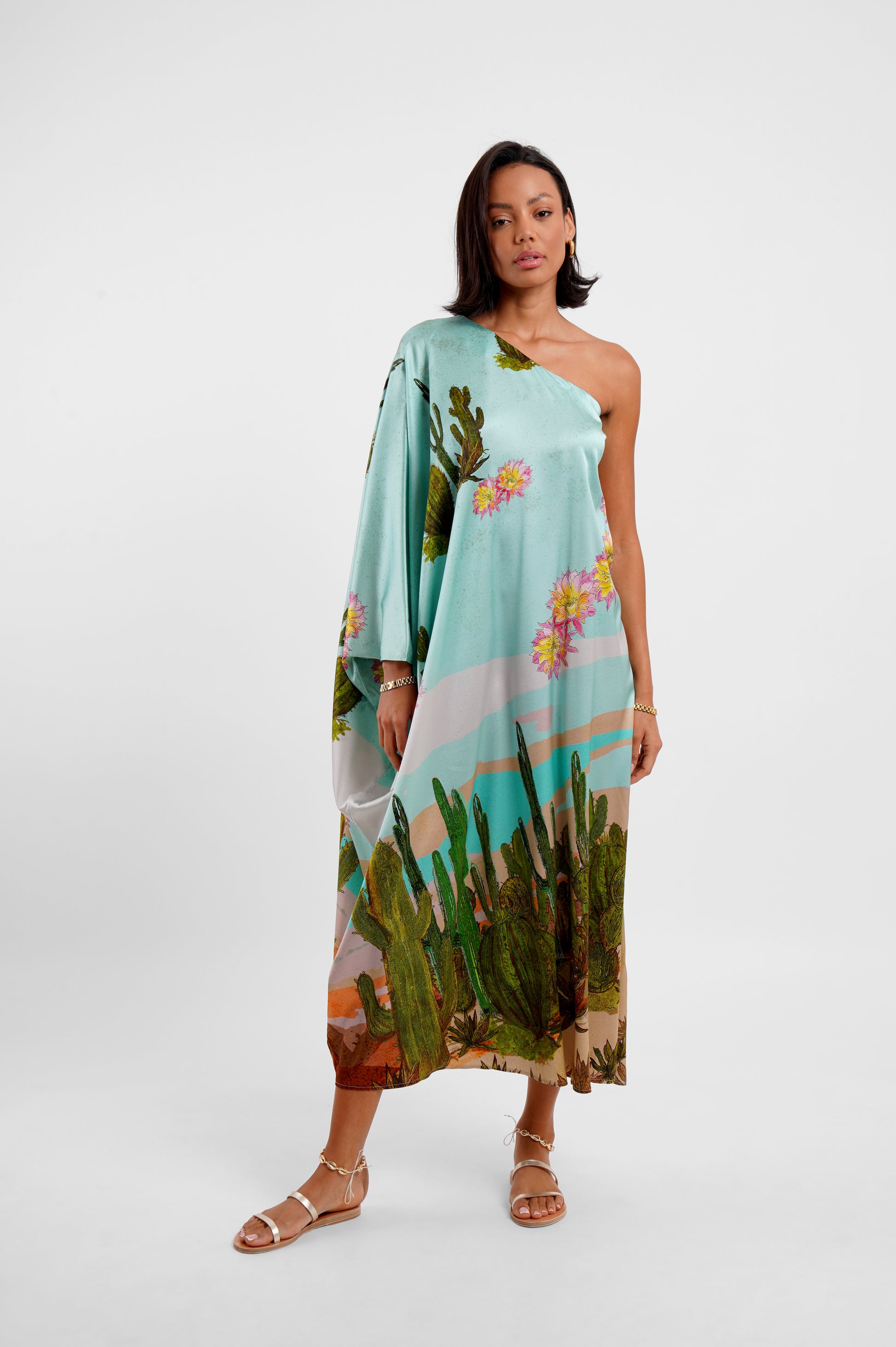 Woman wearing a floral one-shoulder dress on a white background