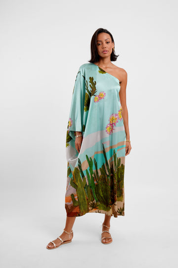 Woman wearing a floral one-shoulder dress on a white background