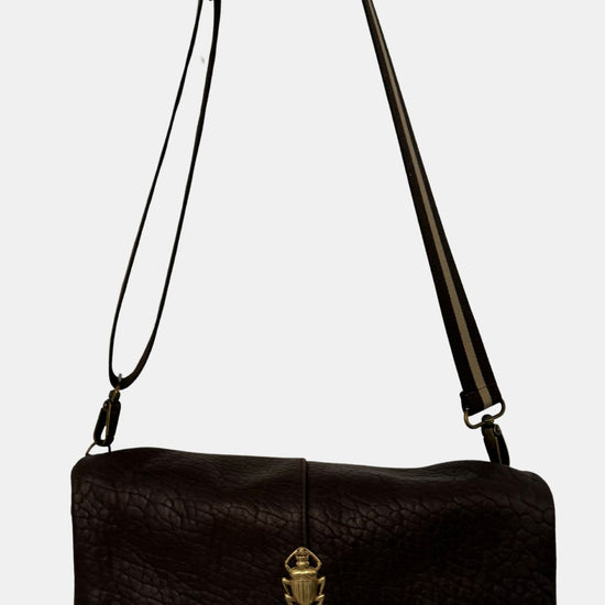 brown lamb leather fold over bag with adjustable strap and gold scarab detail