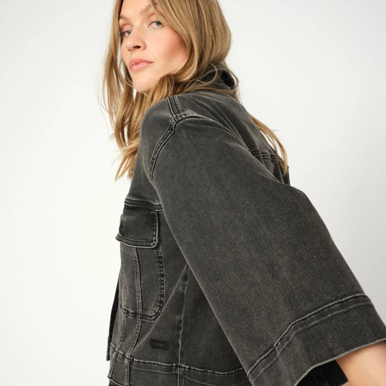 Woman wearing a grey denim jacket on a white background from Mos Mosh