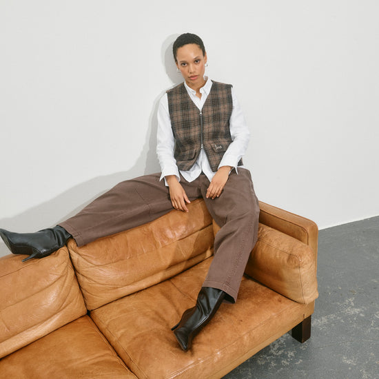 brown barrel leg jeans with pleated front and double button closure model shot