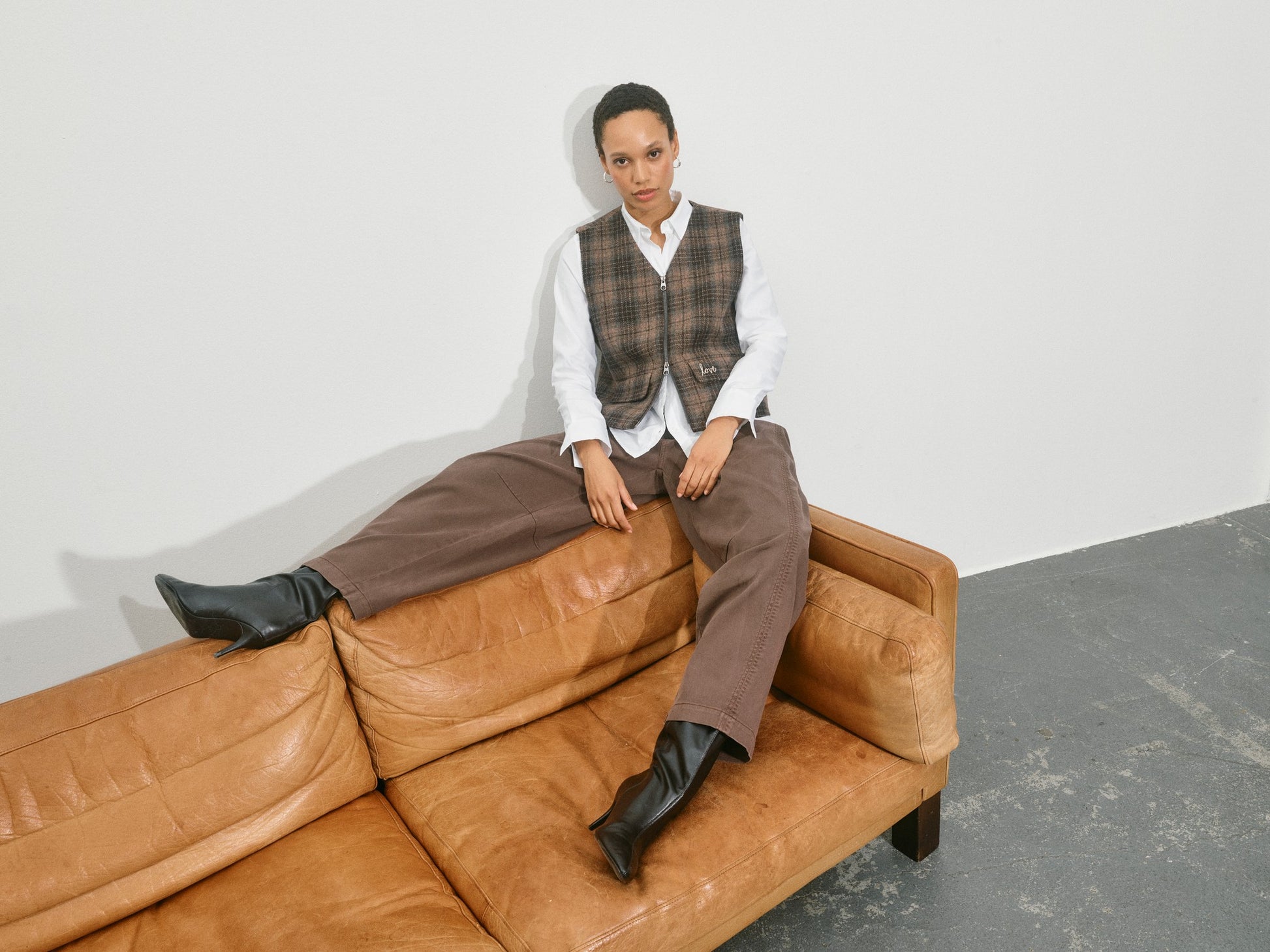 brown barrel leg jeans with pleated front and double button closure model shot