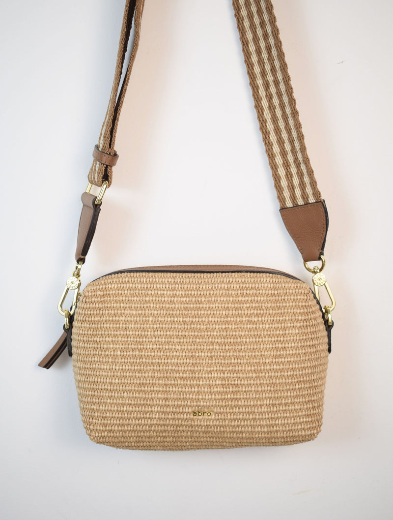 Neutral coloured raffia cross body bag with adjustable strap and leather details
