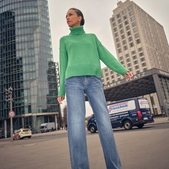 green knitted cotton rollneck with deep ribbed hem, cuffs and neck model shot
