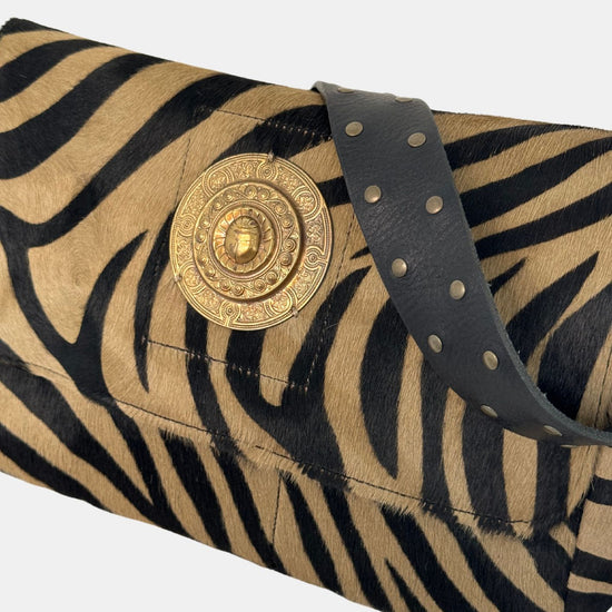 zebra fold over bag with gold emblum and rivet strap