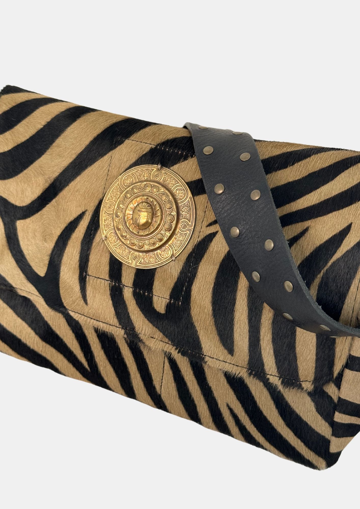 zebra fold over bag with gold emblum and rivet strap