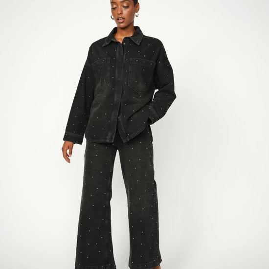 black denim shirt with studs all over model shot with matching trousers