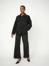 black denim shirt with studs all over model shot with matching trousers