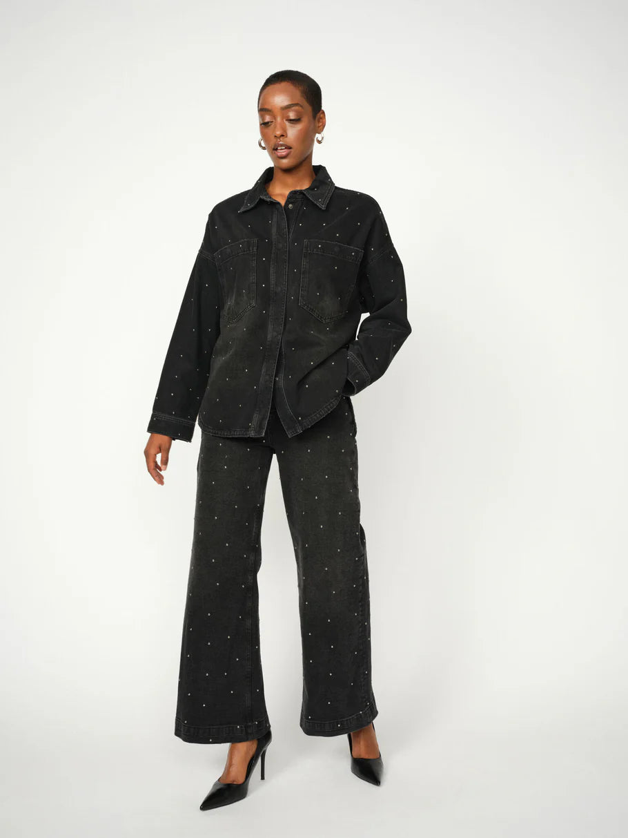 black denim shirt with studs all over model shot with matching trousers