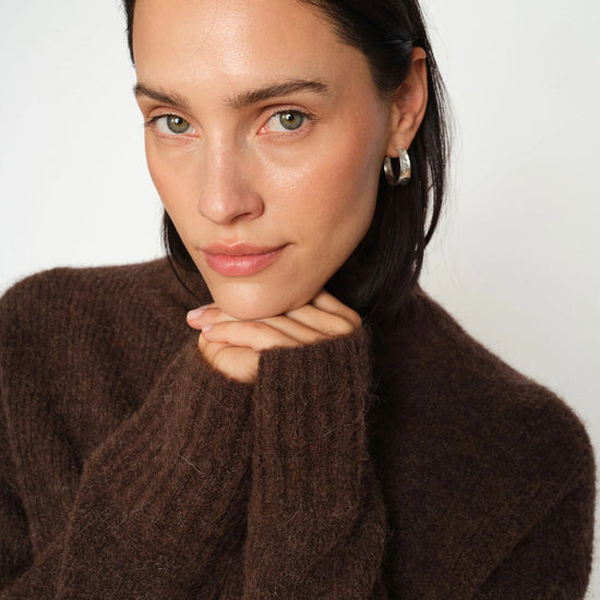model shot of brown turtle neck knit