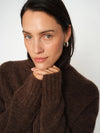 model shot of brown turtle neck knit