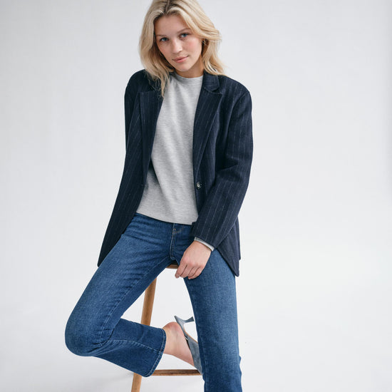 navy wool pinstripe blazer with single breasted, 2 buttons and 2 flap pockets model shot