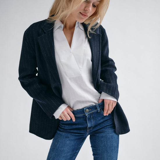 navy wool pinstripe blazer with single breasted, 2 buttons and 2 flap pockets model shot
