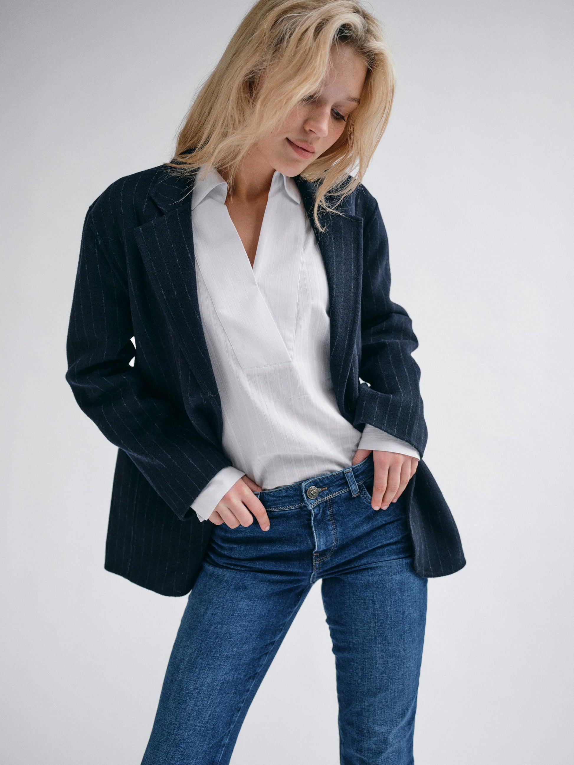 navy wool pinstripe blazer with single breasted, 2 buttons and 2 flap pockets model shot