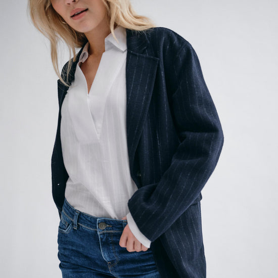 navy wool pinstripe blazer with single breasted, 2 buttons and 2 flap pockets model shot 