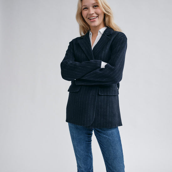 navy wool pinstripe blazer with single breasted, 2 buttons and 2 flap pockets model shot