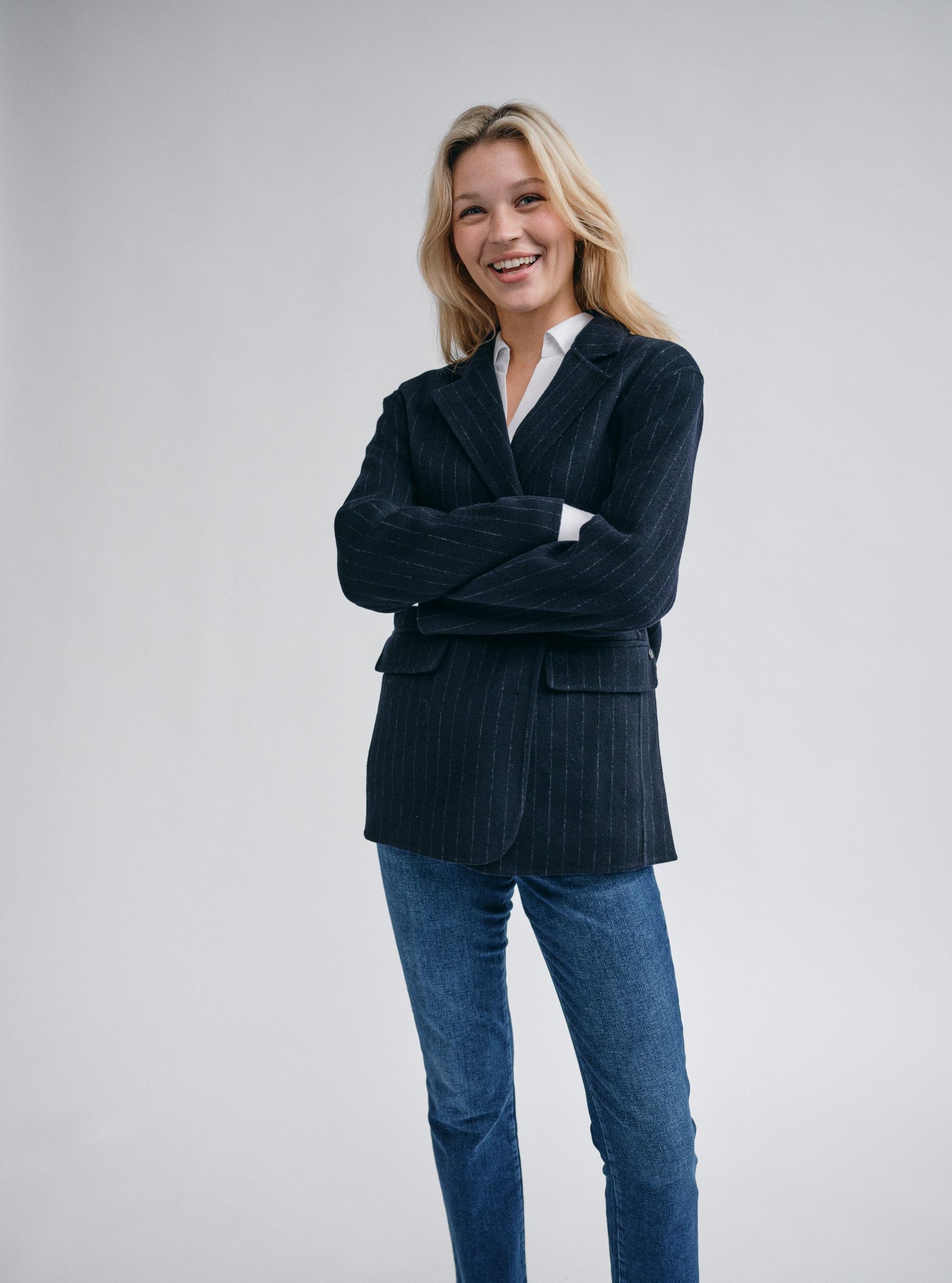 navy wool pinstripe blazer with single breasted, 2 buttons and 2 flap pockets model shot