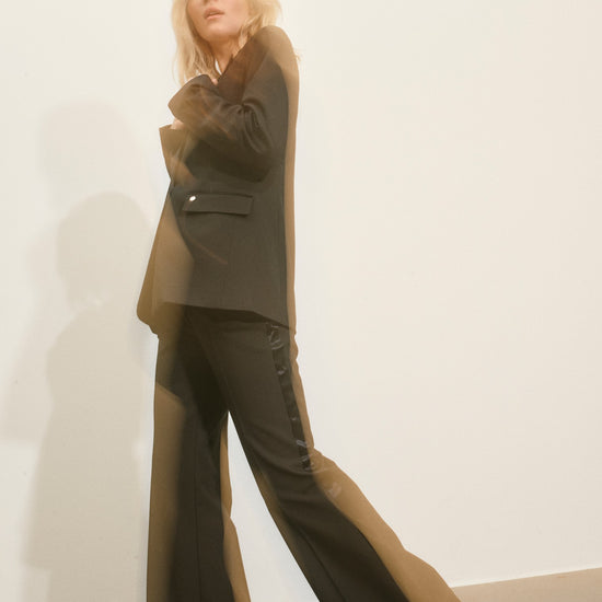 slightly flared black suit trouser with beltloops and pleat down the centre model shot