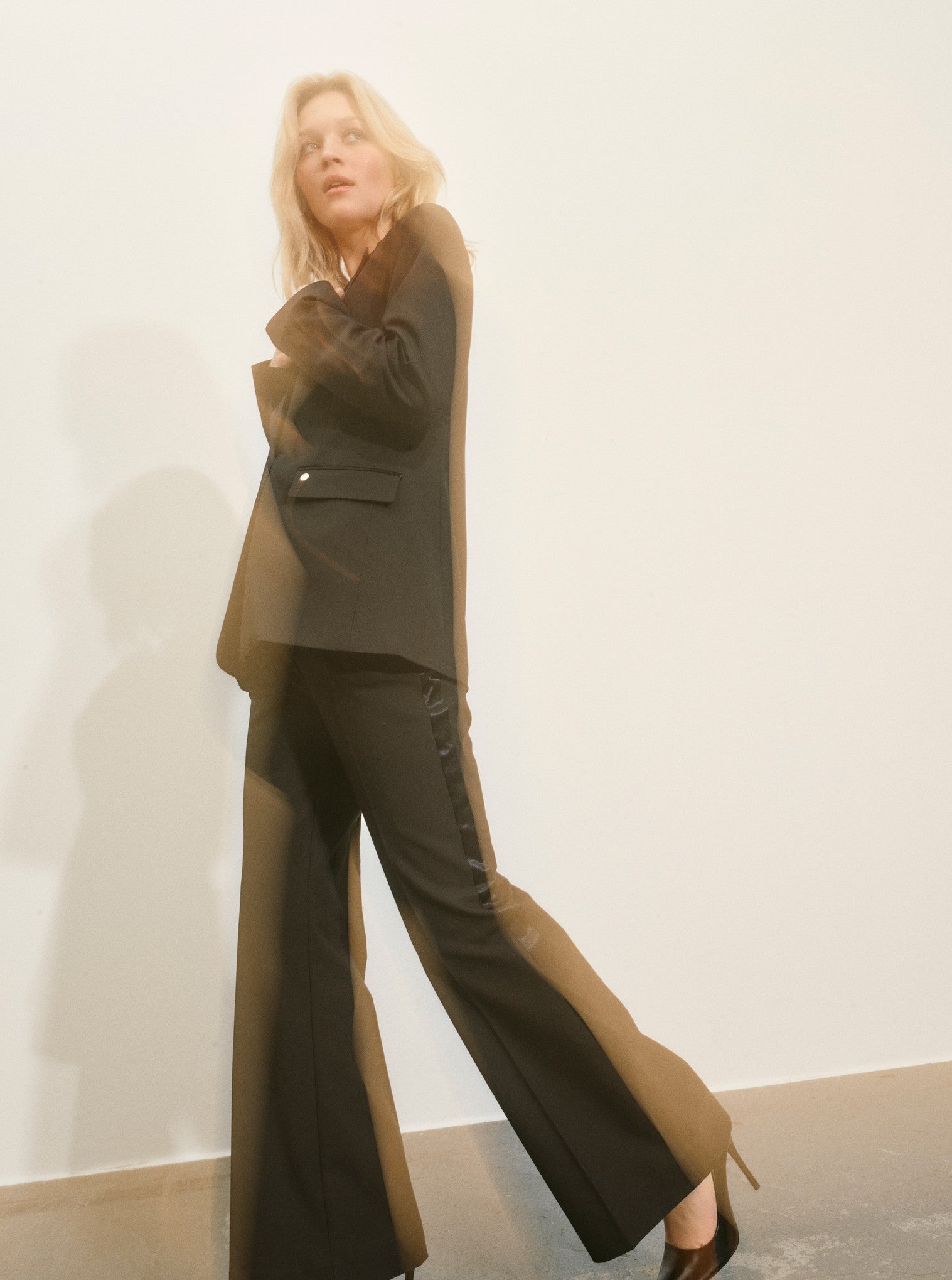 slightly flared black suit trouser with beltloops and pleat down the centre model shot