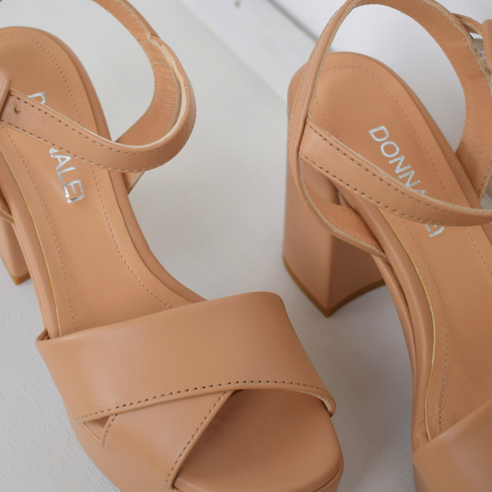 Nude leather platform sandal with cross straps and ankle strap with buckle fastening