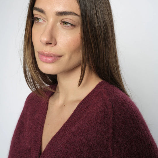 burgundy cardigan on a model close up