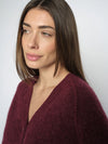 burgundy cardigan on a model close up