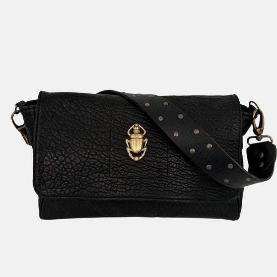 black lamb leather fold over bag with rivet strap and gold scarab emblum