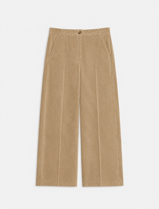 flat lay of cord trousers in a barrel shape on a plain background 
