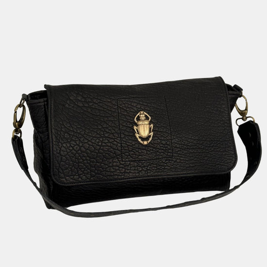 black lamb leather fold over bag with rivet strap and gold scarab emblum