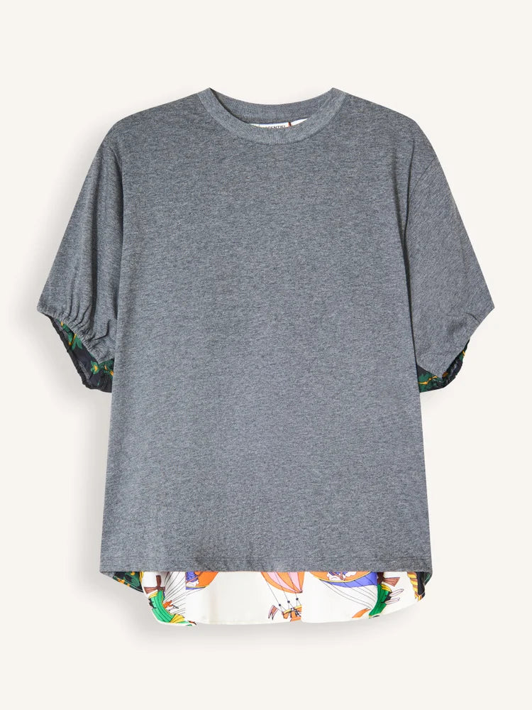 A heather gray short-sleeve t-shirt with a high-low hemline and a colorful abstract pattern lining the hem and sleeve cuffs, displayed against a light off-white background.