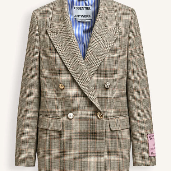 A double-breasted plaid blazer from Antwerp Essentials, featuring a beige and brown check pattern with a blue and white striped inner lining, displayed on a clean off-white background.