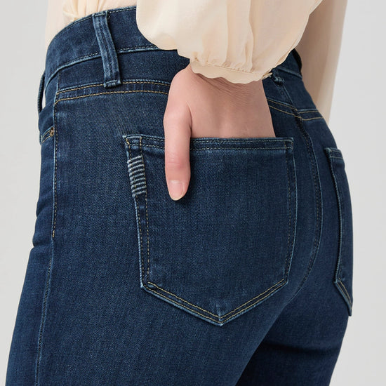 close up of pocket detail on boot cut blue denim jeans from paige