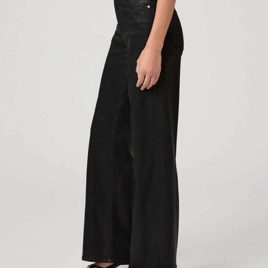 Side view of black wide leg wax jeans