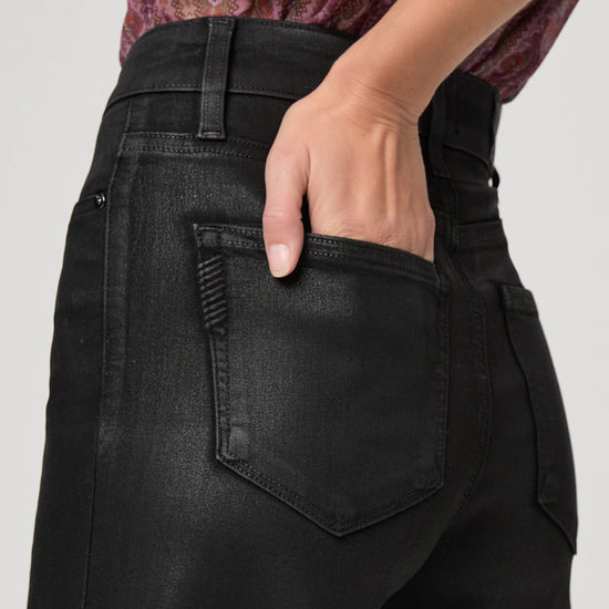 Close up pocket detail on black wax look jeans