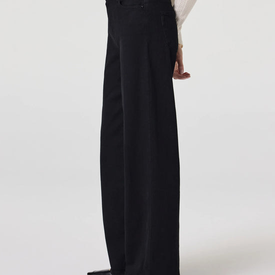 Side view of black wide leg jeans from Paige