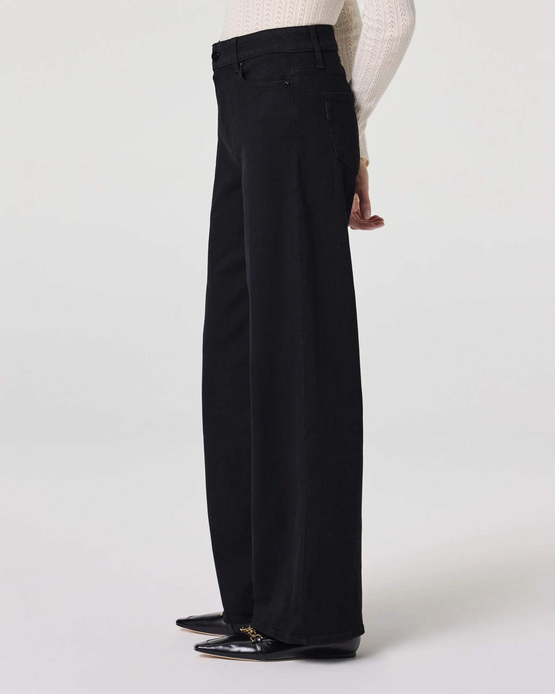 Side view of black wide leg jeans from Paige