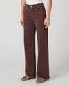 model wearing dark berry coloured jeans and brown shoes on a white background