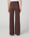 model facing away from the camera with dark berry coloured jeans on on a white background
