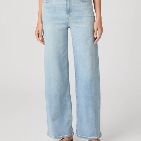 Light blue jeans worn by a person on a white background