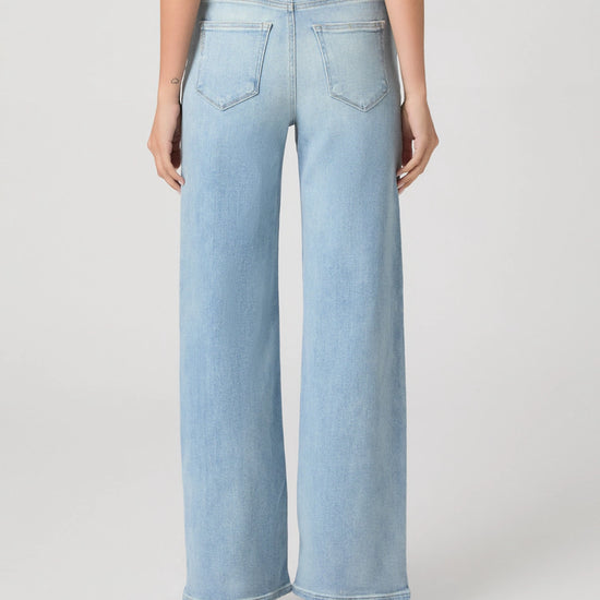 Light blue jeans worn by a person on a white background