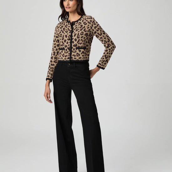 Woman wearing a leopard print cardigan and black jeans from paige