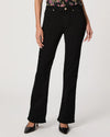 Black bootleg jeans worn by a person on a white background
