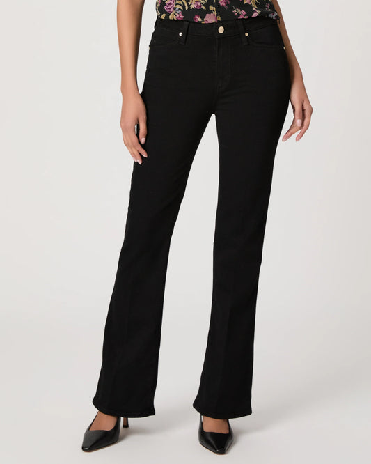 Black bootleg jeans worn by a person on a white background