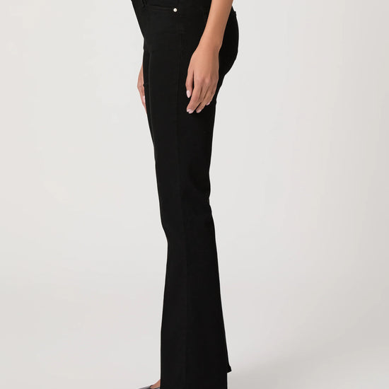 Black flared jeans worn by a person on a white background
