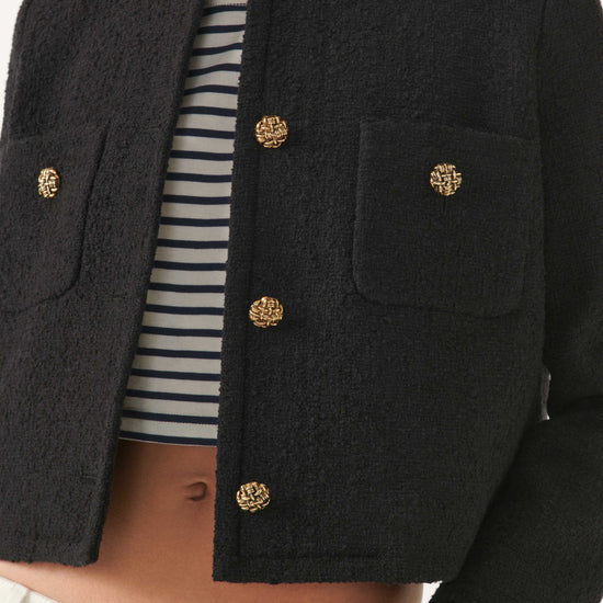 Cropped woven black jacket with two front chest patch pockets and gold buttons